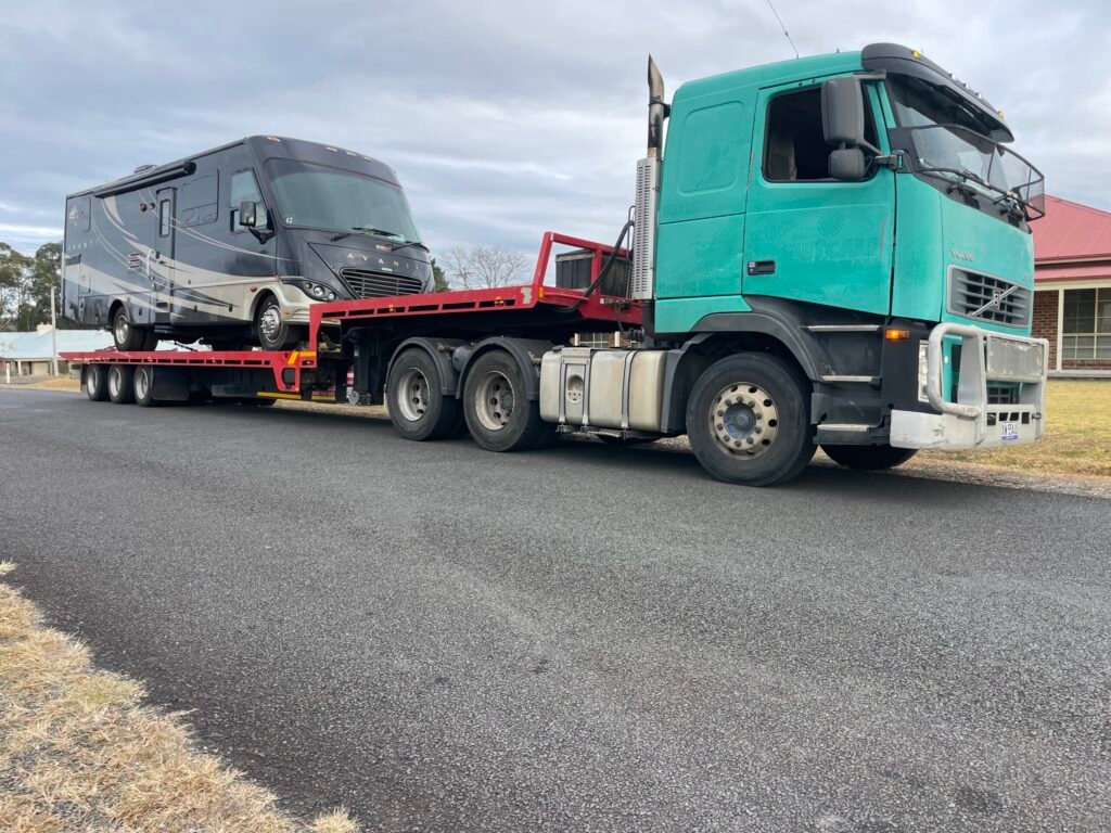 Red Tow Transports Broken-Down Freightliner