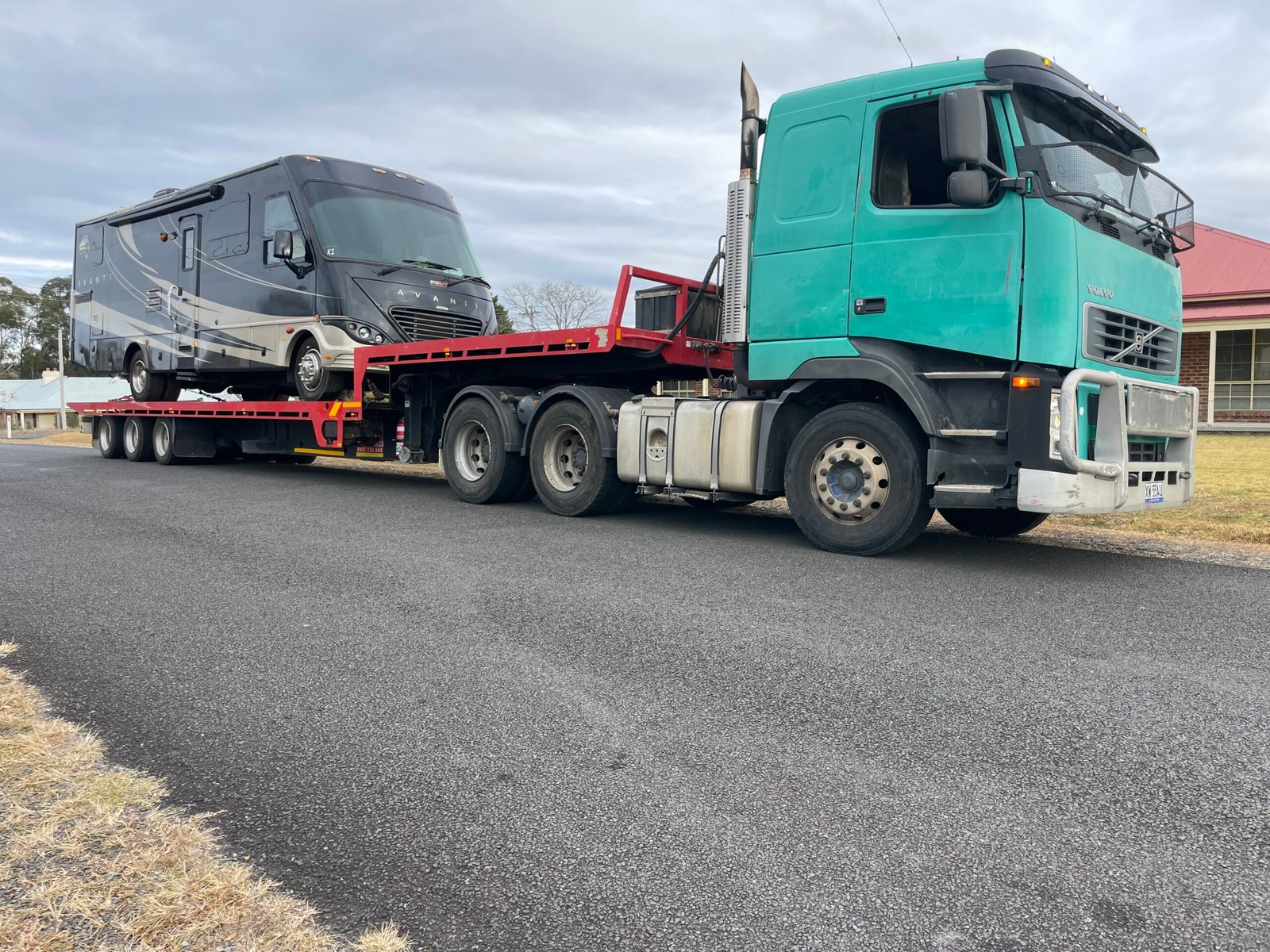 Red Tow Transports Broken-Down Freightliner